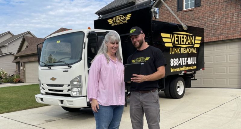 veteran junk removal pro smiling with a junk removal customer