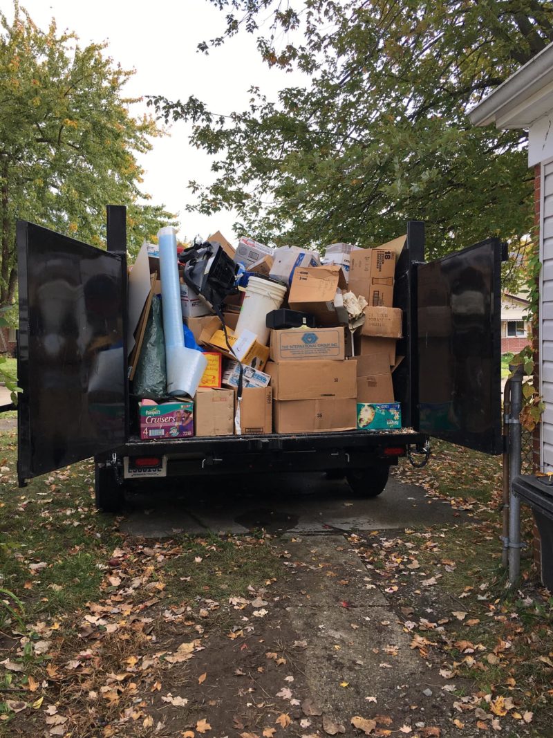 veteran junk removal truck full of boxes and other items